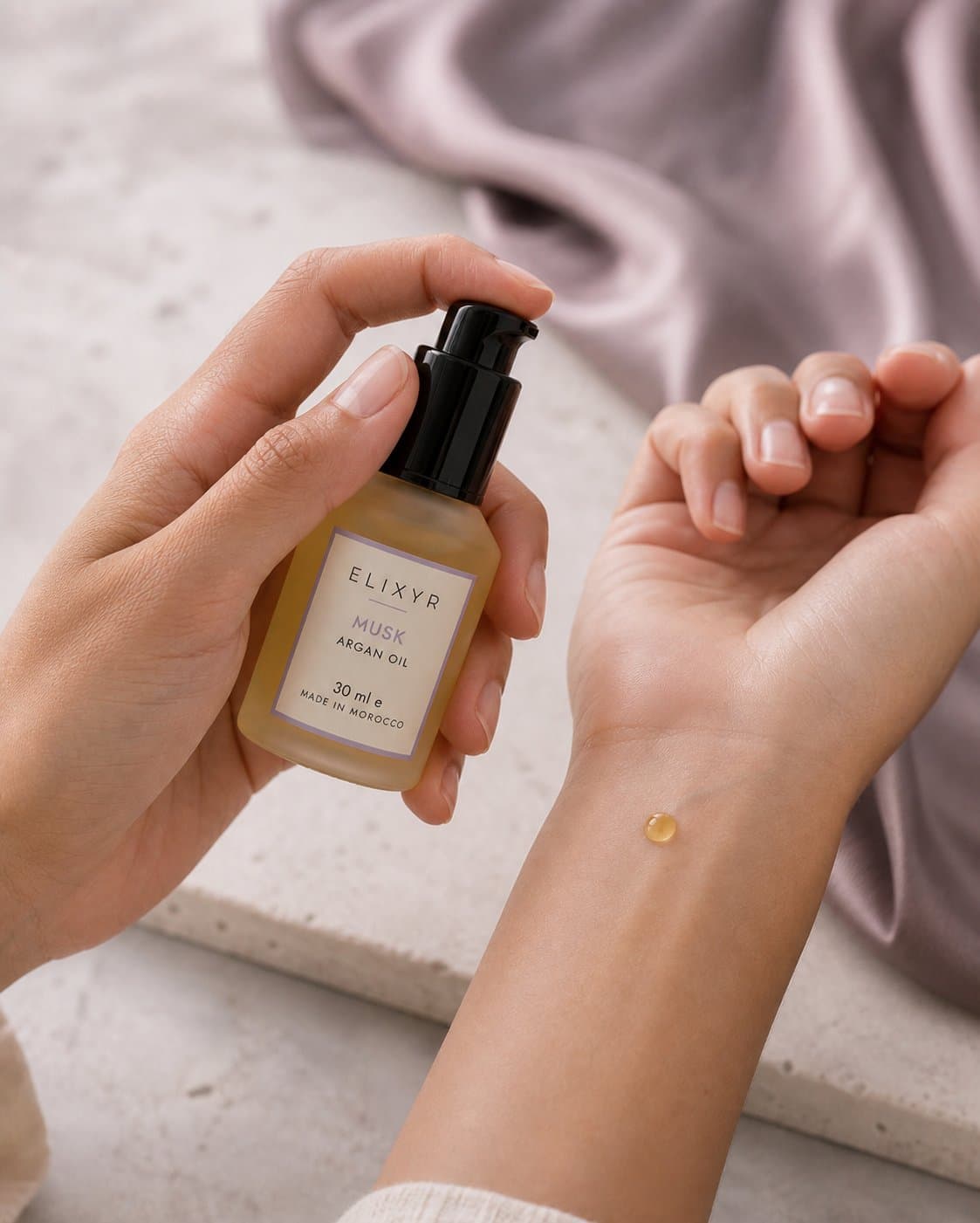 Pressing a drop of argan oil into the inside of the wrist